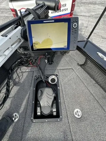 Slide: The Image of 2024 Lund 2175 Pro-V Sport boat with Humminbird fish finder and foot pedal controls. - 17