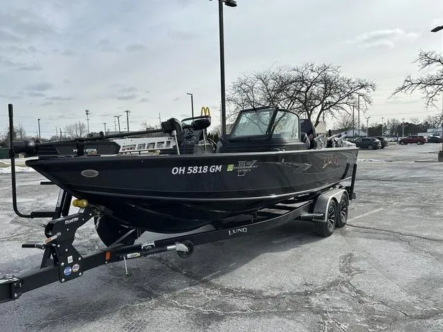 Slide: The Image of 2024 Lund 2175 Pro-V Sport boat on trailer, covered, parked outdoors. - 3