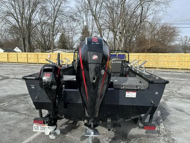 Slide: The Image of 2024 Lund 2175 Pro-V Sport boat on trailer, parked on gravel lot. - 5