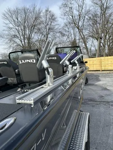 Slide: The Image of 2024 Lund 2175 Pro-V Sport boat interior with fishing gear and dual motors. - 7