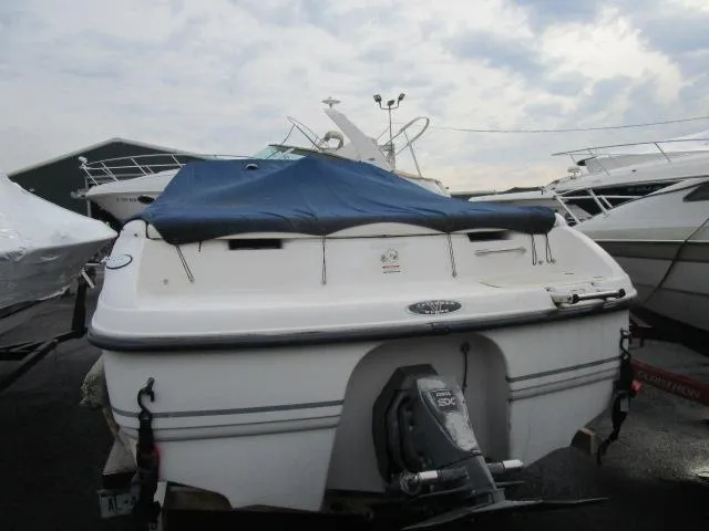 Slide: The Image of 2002 Chaparral 205SSE Cuddy boat with blue cover, docked in marina. - 3