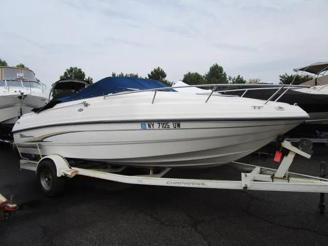 The Image of 2002 Chaparral 205SSE Cuddy boat on trailer, parked outdoors. - 1