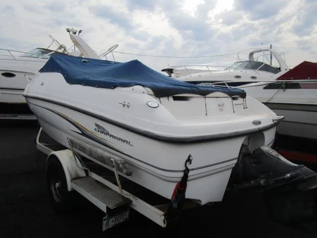Slide: The Image of 2002 Chaparral 205SSE Cuddy boat with blue cover on trailer. - 4