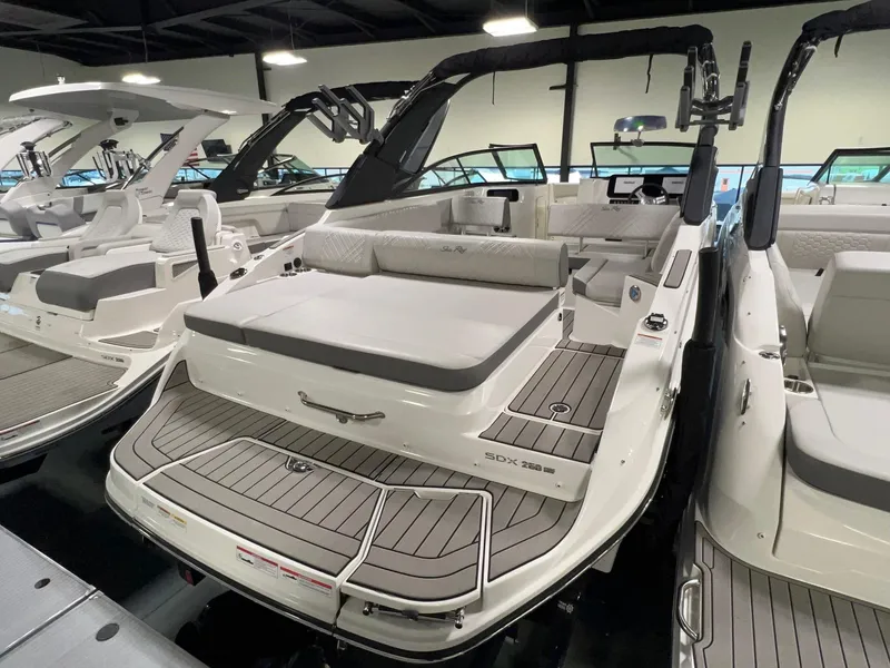 The Image of 2025 Sea Ray SDX 250 Surf boat in showroom, rear view. - 1
