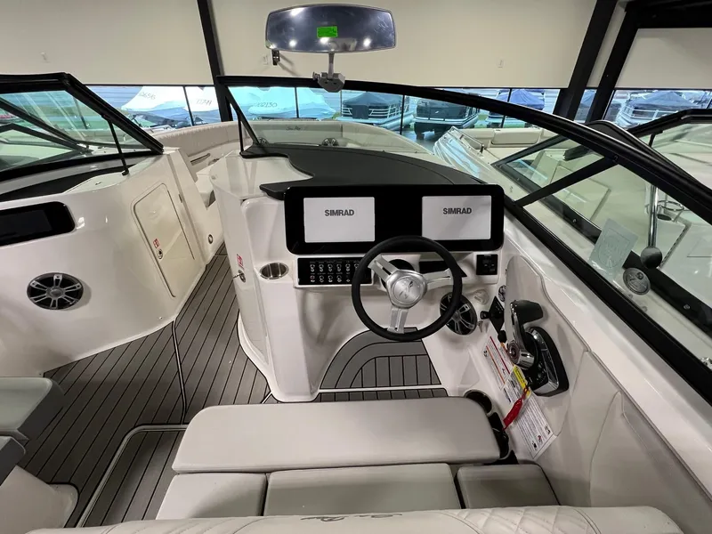 Slide: The Image of Interior of 2025 Sea Ray SDX 250 Surf boat with modern dashboard and steering wheel. - 10