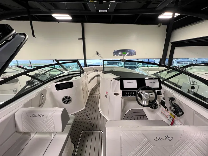 Slide: The Image of 2025 Sea Ray SDX 250 Surf boat interior with modern dashboard and seating. - 11