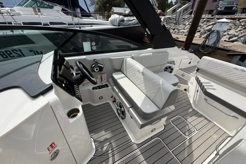 Slide: The Image of 2025 Sea Ray SDX 250 Surf boat interior with sleek seating and modern dashboard design. - 9