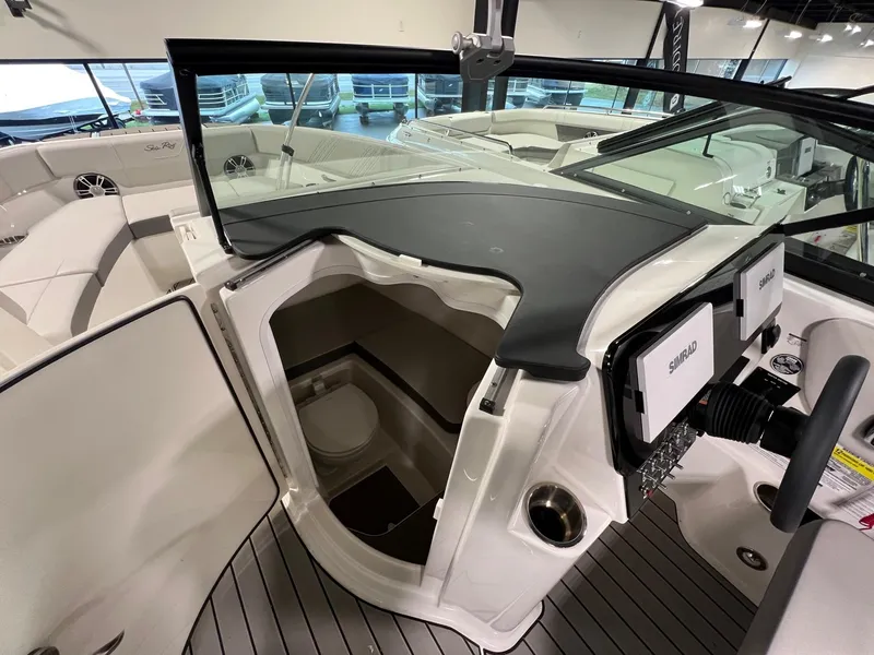 Slide: The Image of 2025 Sea Ray SDX 250 Surf boat interior with helm and cabin view. - 15