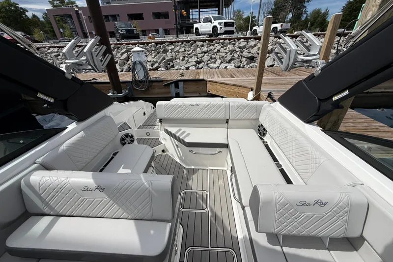 Slide: The Image of 2025 Sea Ray SDX 250 Surf boat interior with luxurious white seating and modern design. - 6