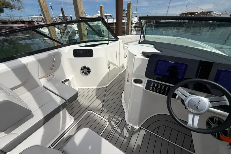 Slide: The Image of 2025 Sea Ray SDX 250 Surf boat interior with modern dashboard and seating. - 11