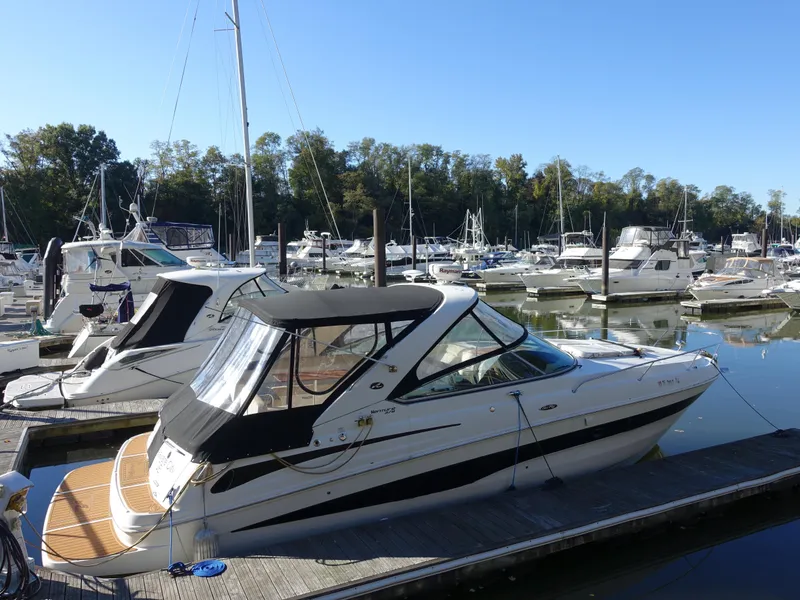 The Image of 2013 Sea Ray 370 Venture docked at a marina with other boats. - 0
