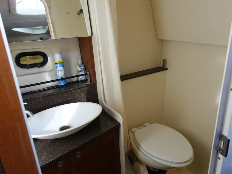 Slide: The Image of 2013 Sea Ray 370 Venture bathroom with sink, mirror, and toilet. - 10