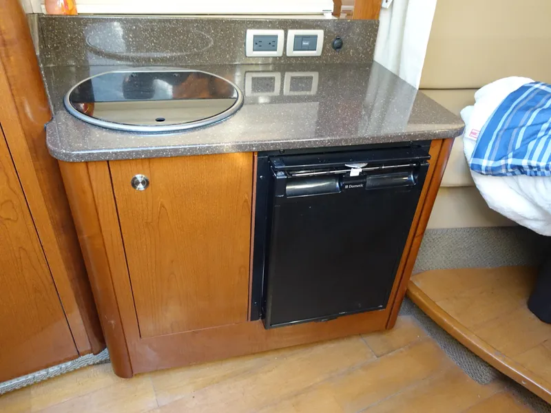 Slide: The Image of Compact kitchenette in 2013 Sea Ray 370 Venture with sink and mini fridge. - 11