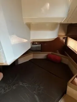 Slide: The Image of 2013 Sea Ray 370 Venture cabin interior with cozy seating and modern design. - 14