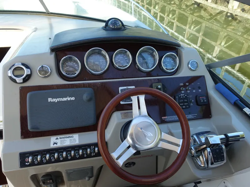 Slide: The Image of Dashboard of 2013 Sea Ray 370 Venture boat with steering wheel and gauges. - 3