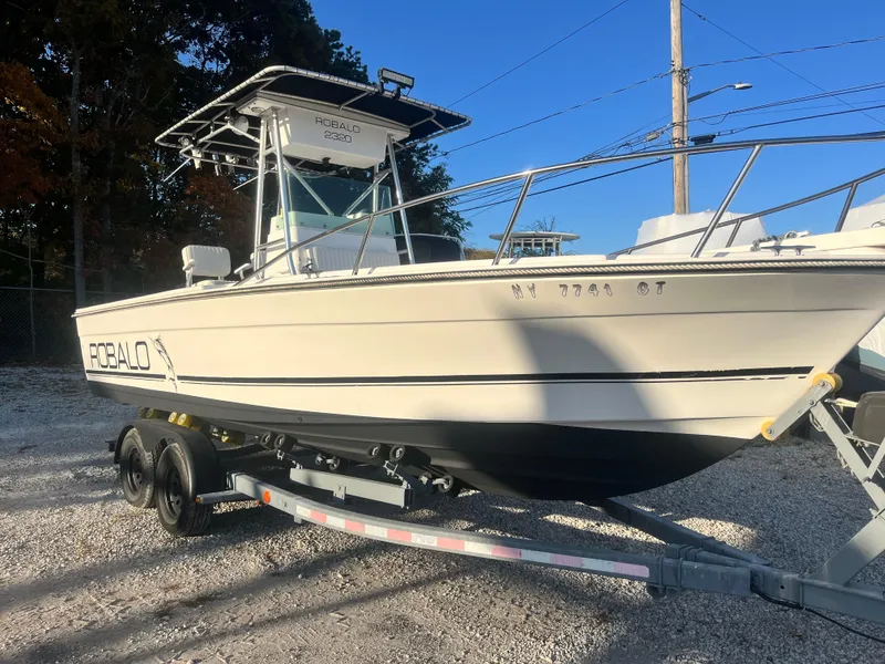 Slide: The Image of 1994 Robalo 23 boat with Merc Optimax 225 outboard on trailer, parked outdoors. - 0