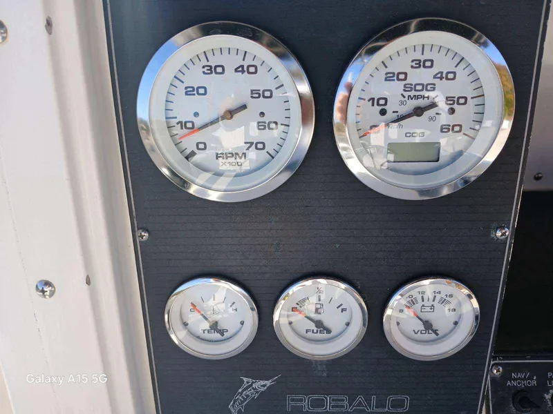 Slide: The Image of Dashboard of 1994 Robalo 23 with Merc Optimax outboard gauges. - 16
