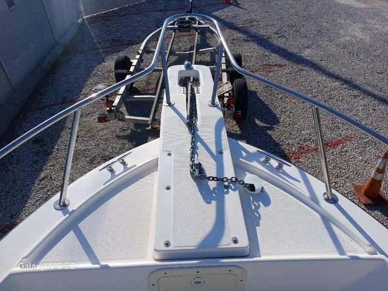Slide: The Image of 1994 Robalo 23 boat with Merc Optimax outboard 225, on a trailer, gravel background. - 19