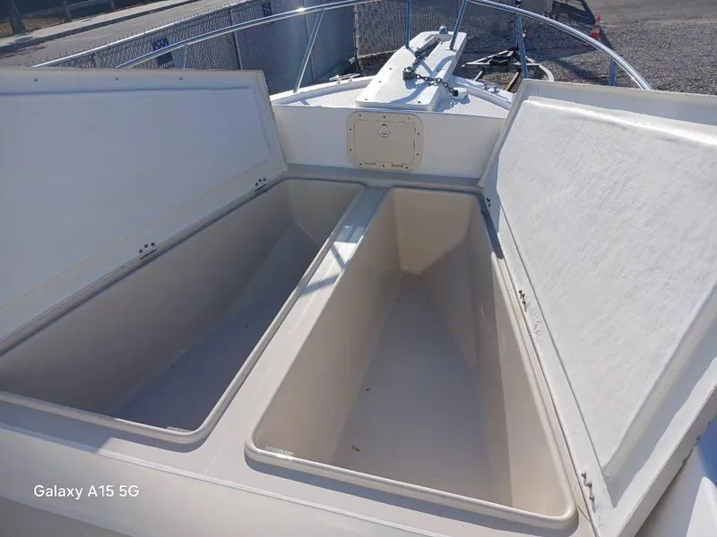 Slide: The Image of Open storage compartments on a 1994 Robalo 23 boat deck. - 23