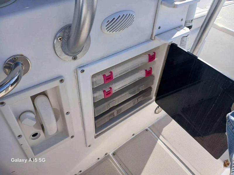 Slide: The Image of Robalo 23 boat storage compartments with tackle boxes, 1994 model. - 24