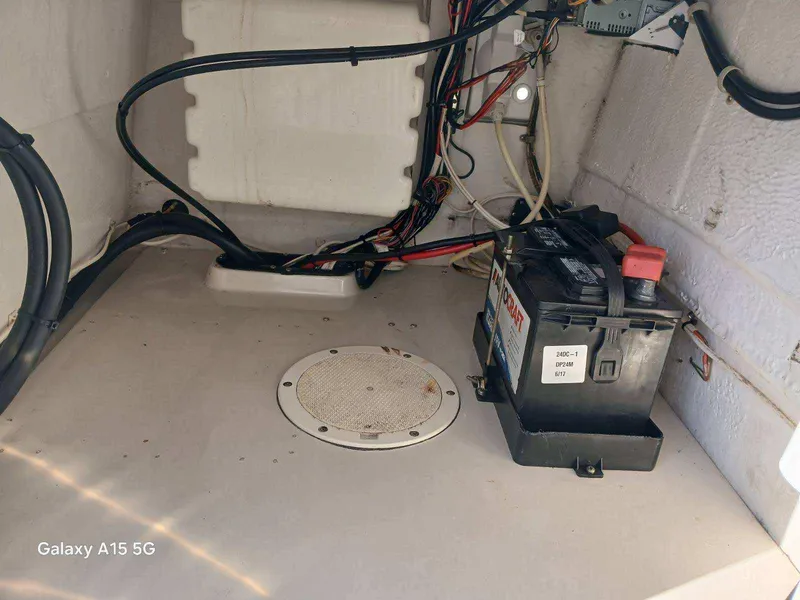 Slide: The Image of 1994 Robalo 23 boat interior showing battery and wiring setup. - 31