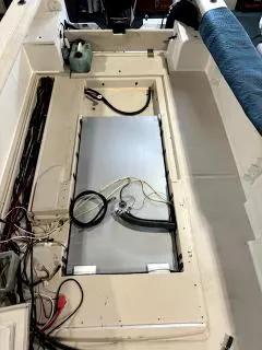 Slide: The Image of 1994 Robalo 23 boat interior with exposed wiring and components. - 33