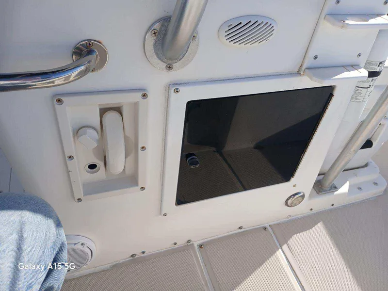 Slide: The Image of Interior view of a 1994 Robalo 23 boat, featuring control panel and storage compartment. - 32