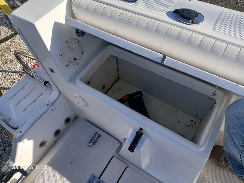 Slide: The Image of Open storage compartment on 1994 Robalo 23 boat with Merc Optimax outboard 225. - 9