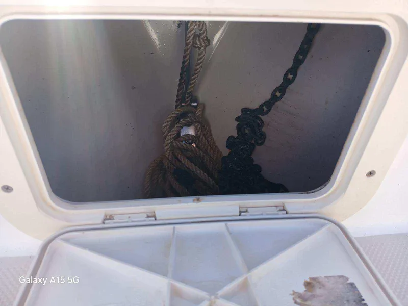 Slide: The Image of Anchor storage compartment on a 1994 Robalo 23 boat with rope and chain. - 27