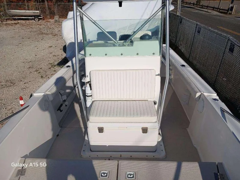 Slide: The Image of 1994 Robalo 23 boat interior with seating and console, featuring Merc Optimax outboard 225. - 25