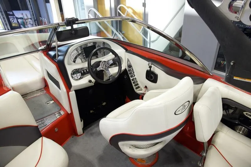 Slide: The Image of 2008 Centurion Enzo SV230 boat interior with white and red seating, modern dashboard, and steering wheel. - 12