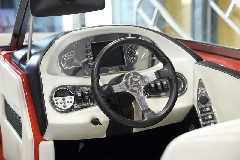 Slide: The Image of 2008 Centurion Enzo SV230 boat dashboard with steering wheel and control panel. - 13