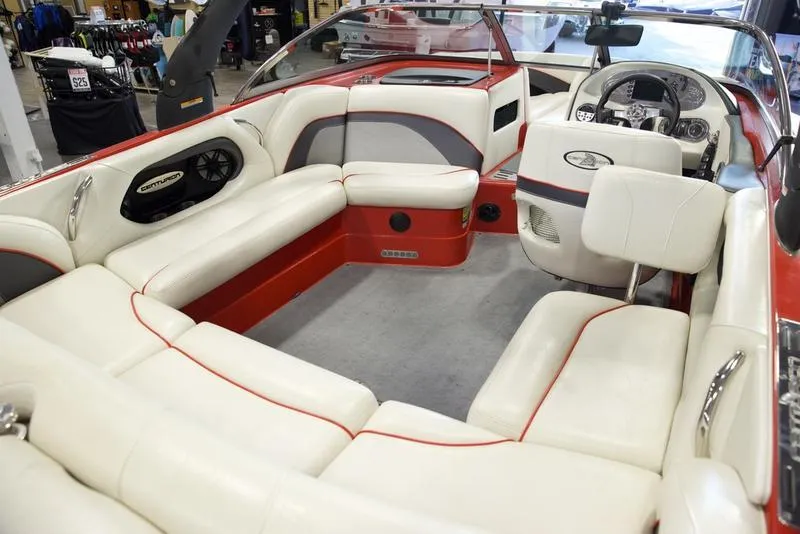 Slide: The Image of 2008 Centurion Enzo SV230 boat interior with white and red seating, modern dashboard, and spacious layout. - 15