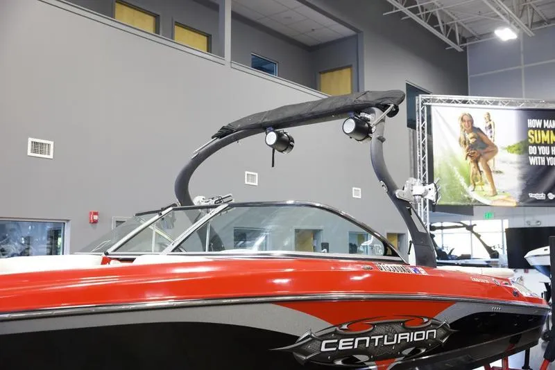 Slide: The Image of 2008 Centurion Enzo SV230 boat in showroom, red and black design. - 8