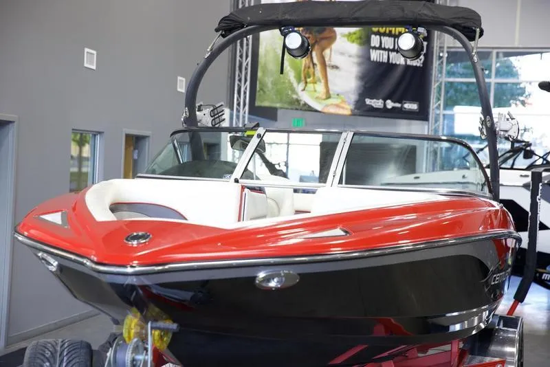 Slide: The Image of 2008 Centurion Enzo SV230 boat with red and black exterior in showroom. - 9