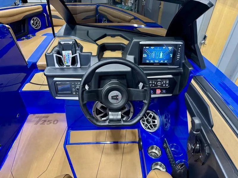 Slide: The Image of 2022 Axis T250 boat cockpit with steering wheel, touchscreen display, and blue interior accents. - 10