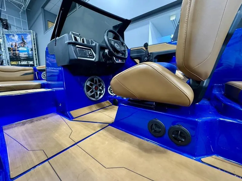 Slide: The Image of 2022 Axis T250 boat interior with blue accents and tan seating. - 11