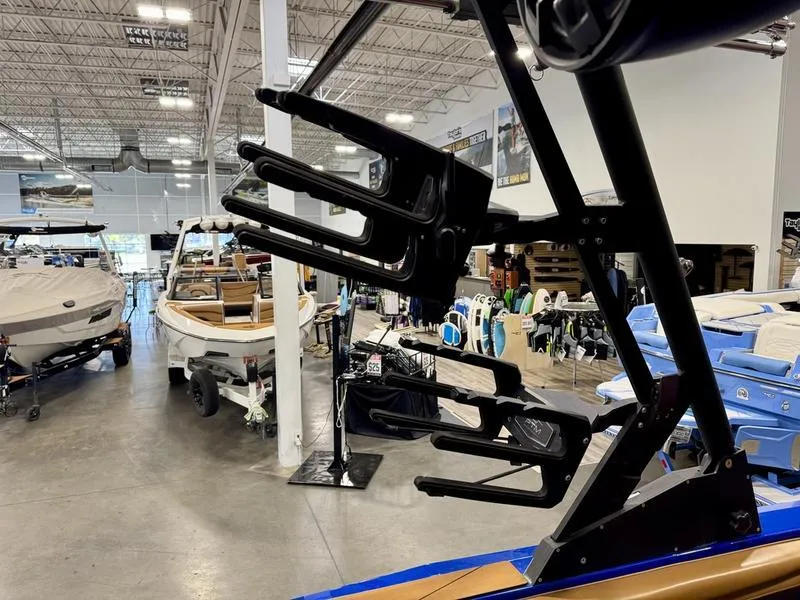 Slide: The Image of 2022 Axis T250 boat in showroom with wakeboard rack and other boats. - 16