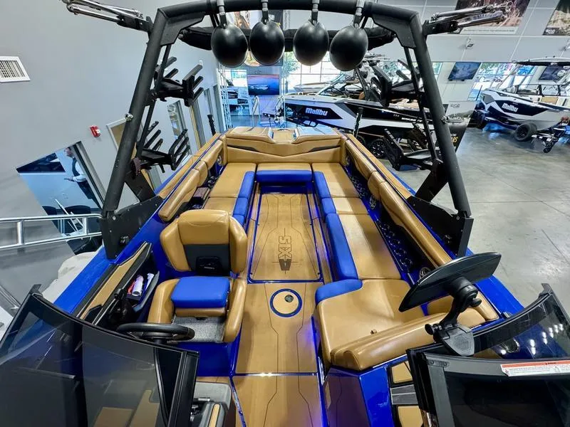 Slide: The Image of 2022 Axis T250 boat interior with blue and tan seating, modern design, and advanced controls. - 18