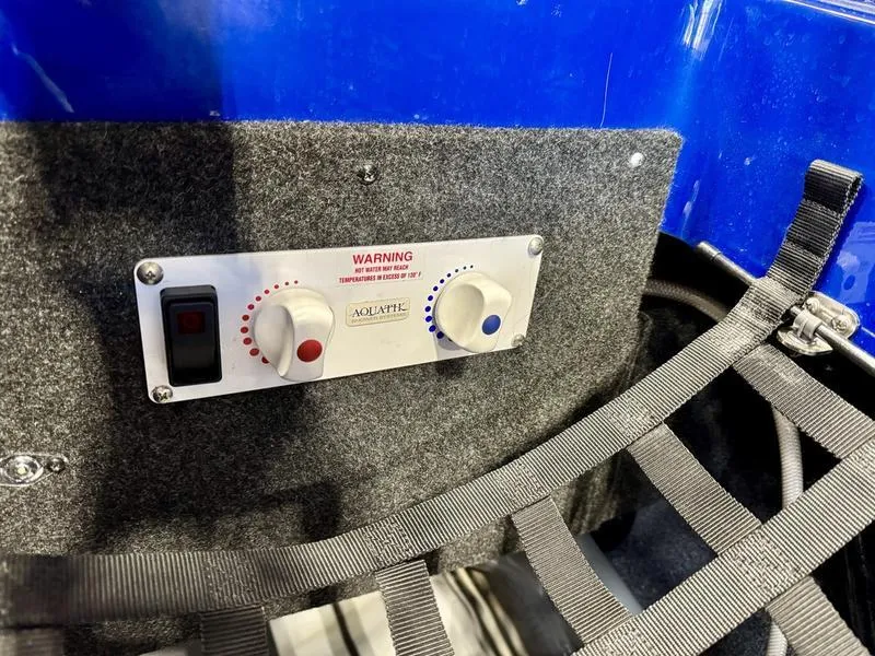 Slide: The Image of Control panel of 2022 Axis T250 boat with temperature dials and warning label. - 20