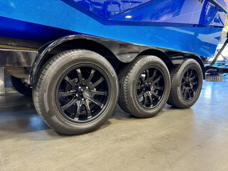 Slide: The Image of 2022 Axis T250 boat trailer with triple black wheels on display. - 4