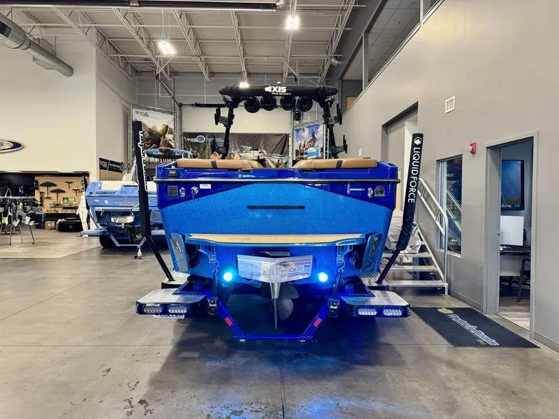 Slide: The Image of 2022 Axis T250 boat in showroom, rear view with blue lighting. - 5