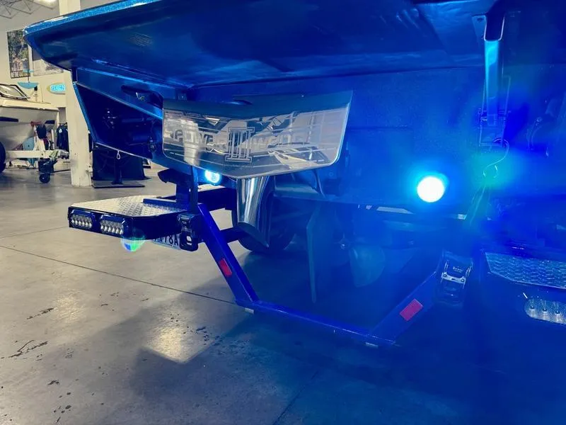 Slide: The Image of 2022 Axis T250 boat with illuminated blue underwater lights in a garage. - 6