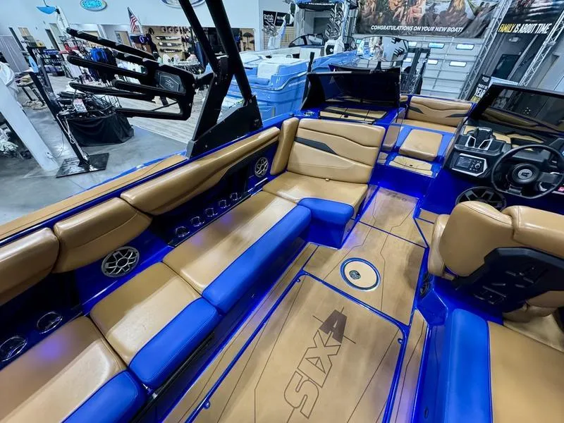 Slide: The Image of 2022 Axis T250 boat interior with tan and blue seating, modern dashboard, and spacious layout. - 8