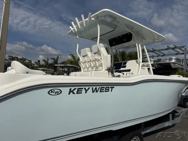 Slide: The Image of 2025 Key West 263 FS boat, spacious deck, white interior, parked outdoors. - 12