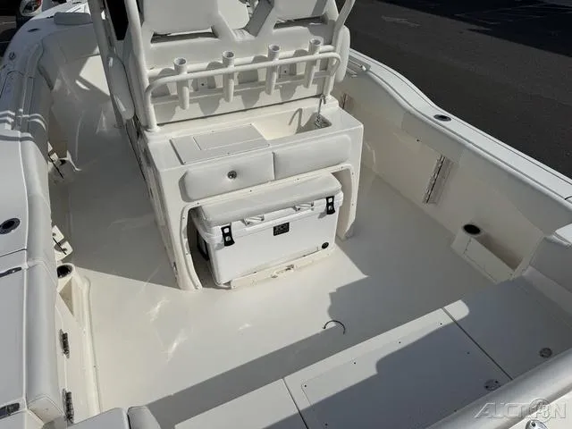 Slide: The Image of 2025 Key West 263 FS boat with T-top and rod holders in a marina. - 14