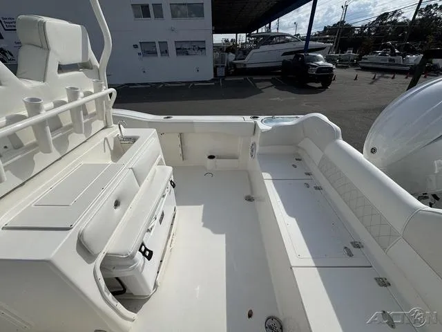 Slide: The Image of 2025 Key West 263 FS boat interior with helm and seating under a clear sky. - 26