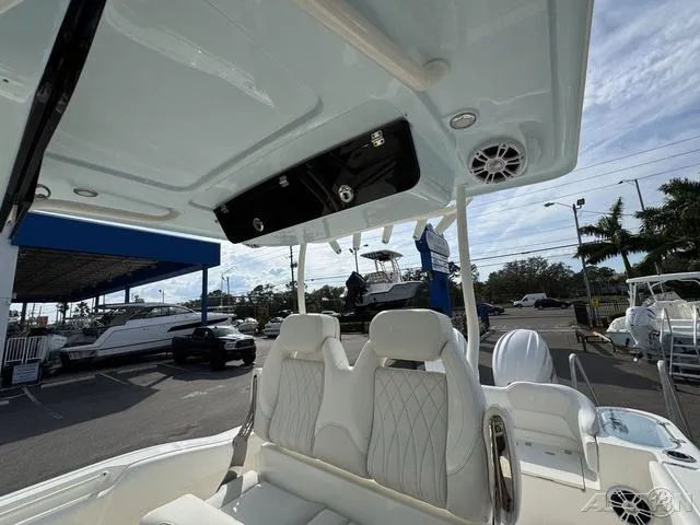 Slide: The Image of 2025 Key West 263 FS boat interior with white seating and steering wheel. - 32