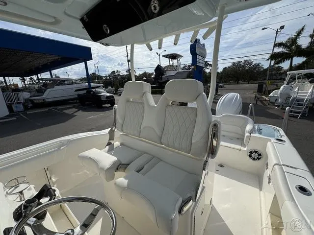 Slide: The Image of 2025 Key West 263 FS boat interior with steering wheel and white seating. - 33