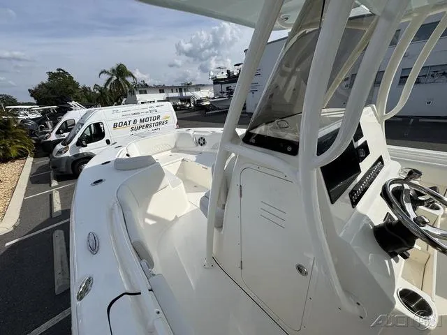 Slide: The Image of 2025 Key West 263 FS boat interior with white seating, parked at dealership. - 35